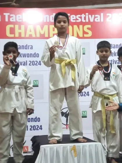 Hamdan Ansari stands tall on the first-place podium after winning a gold medal at the Bandra Taekwondo Festival. We train our fighters to aim for the top.