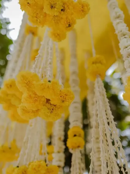 A close-up of the handcrafted floral strings used in the Haldi decor.