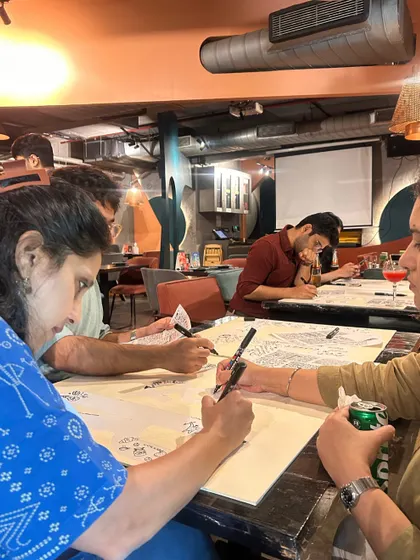 Participants at the Google workshop, deep in concentration. Everyone gets their own section to doodle, making it a personal yet shared experience.