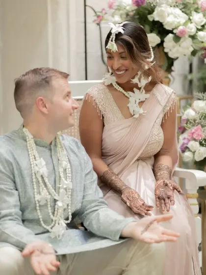 A candid interaction between the couple, their hands telling a story of their own.