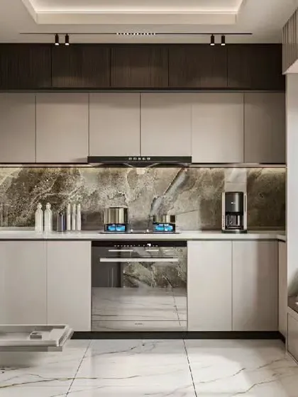 This U-shaped kitchen features integrated appliances, including a dishwasher. The design combines neutral cabinets with a dramatic marble backsplash and a window seat for extra functionality.