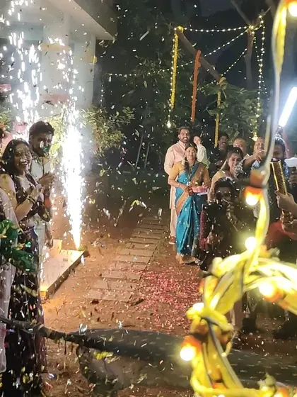 A close-up of the celebratory entrance, capturing the happy faces of the guests as they welcome the couple. The entire atmosphere is electric with excitement.