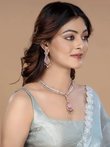 A model wearing a contemporary diamond and pink stone necklace set, shot against a neutral background to make the jewellery pop.