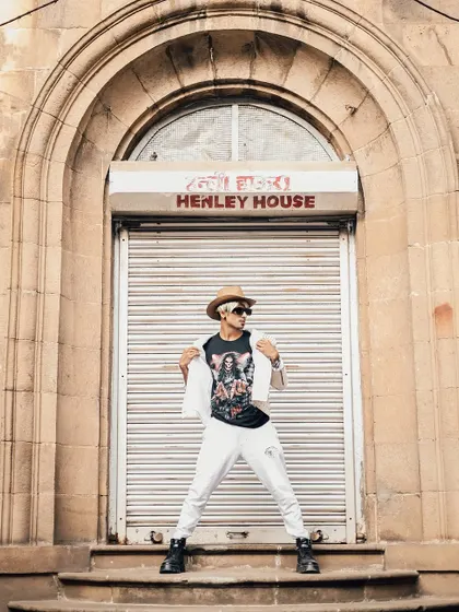 A reveal shot from the themed shoot, showing the graphic tee under the jacket.