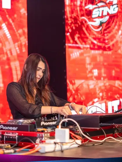 A focused shot of me mixing on the red-themed Sting stage at the Kaavaalaa festival. I am comfortable and skilled at performing in high-pressure, branded environments.
