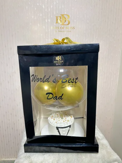 The full view of the tuxedo cake and balloon hamper, presented in a sleek black display box.