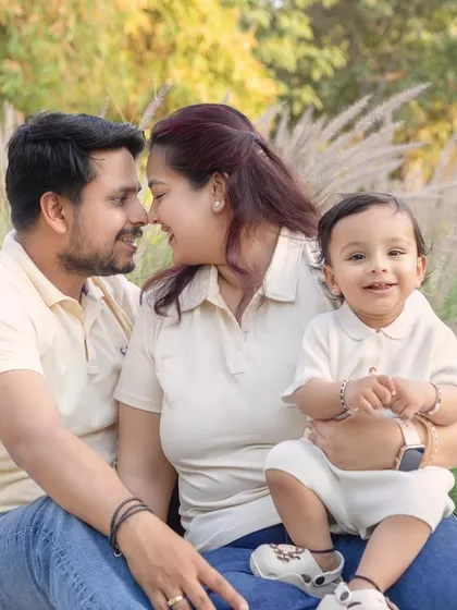 A sweet, romantic moment between parents while their son smiles for the camera. Outdoor sessions allow for a beautiful mix of candid and posed shots.