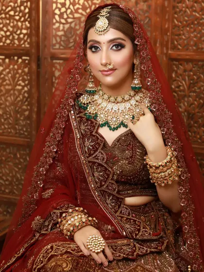 This bride's final look is a testament to the power of professional makeup and styling. She looks absolutely regal in her red and gold attire.
