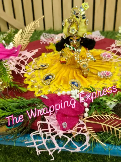 A close-up of the decorated Kanha ji idol for a Teej gift hamper.
