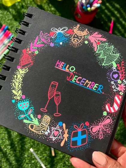 Holding up the completed "Hello December" festive doodle.