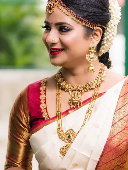 Another angle of this stunning South Indian bridal look, capturing the intricate details of her antique gold jewellery and the rich texture of her silk saree.