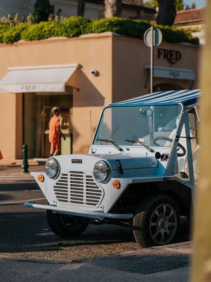 A classic Mini Moke, the quintessential St. Tropez vehicle, parked on a street. Capturing iconic local elements like this adds a strong sense of place.