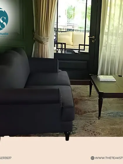 Another view of this classic dark grey sofa, showcasing its clean silhouette and sturdy construction. It's a versatile piece that provides both comfort and understated style.