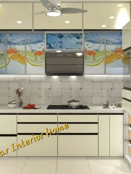 A close-up of the white kitchen with the citrus backsplash, showing the clean lines of the handleless drawers.