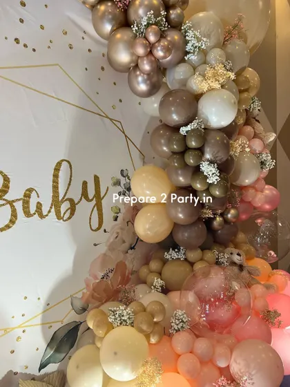 A close-up of the balloon work on the "Oh Baby" backdrop, showing the mix of different sizes and shades of balloons that create a lush, textured look.