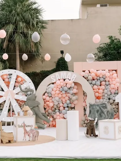 We brought a soft, pastel jungle to life for a little one's first birthday. This wide view showcases the complete themed environment, featuring gentle animal props, custom backdrops, and dreamy balloon installations for a magical celebration.
