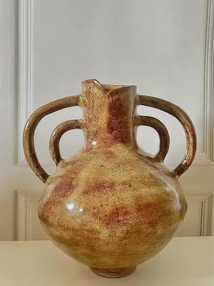 The same hand-built vase, showing a different side with more reddish tones in the glaze.