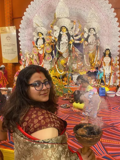 Here I am, participating in the Dhunuchi Naach. It's important for me to not just observe but also feel the energy of the festivals I document.