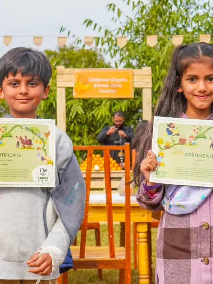 Two children showing off their certificates, a wonderful souvenir from their day of learning and play.