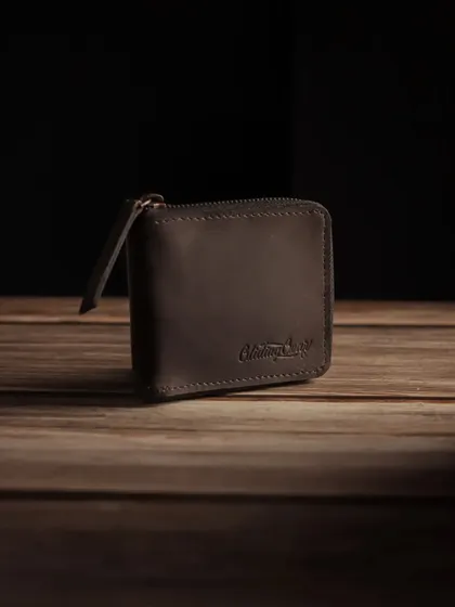 A close up of the Glidinggear wallet, focusing on the embossed logo and the texture of the leather.