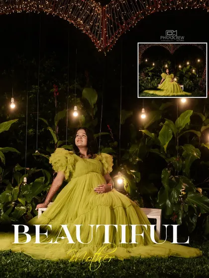 A showcase of our creative night-time maternity shoots. Here, Deepa is seated in a lush garden setting, illuminated by hanging bulbs and a heart-shaped light installation, creating a truly magical and romantic atmosphere.