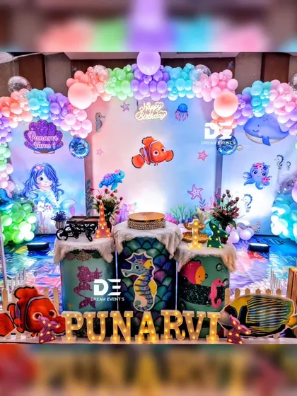 A closer look at the vibrant stage for Punarvi's mermaid party, filled with colorful sea creatures, themed pedestals, and a beautiful underwater backdrop.