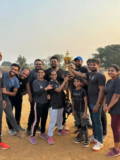 The champions celebrating with their trophy. The joy of a team victory is a powerful motivator.