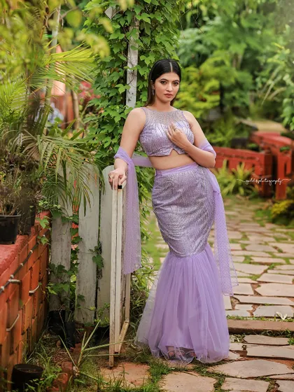 A designer shoot for a modern lavender lehenga. The images were taken in a lush garden, with the purple flowers complementing the color of the outfit, creating a soft and romantic fashion story.