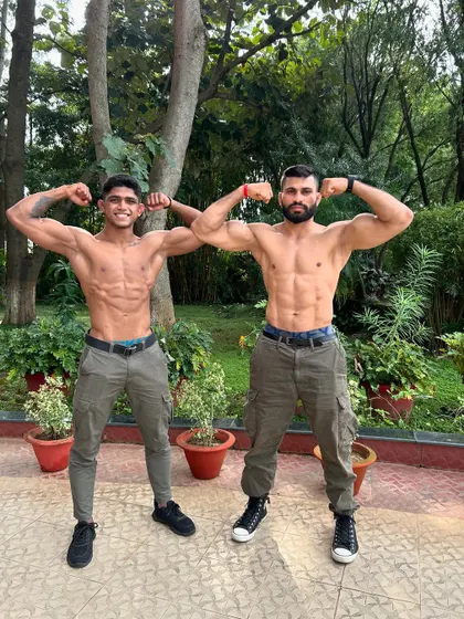 The physical results of relentless training. Two of our fighters showcasing their lean, powerful physiques earned through our combat conditioning programs.