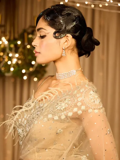 A side profile of the Gatsby-inspired updo. The sleek waves and low bun create a very elegant and sophisticated silhouette.