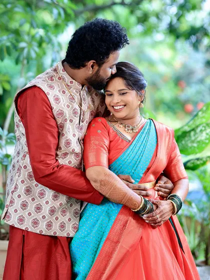 A sweet moment between the couple. The bride's makeup looks beautiful in the natural outdoor light, a testament to a well-executed application.