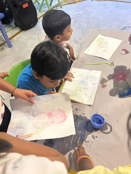 Two young children deeply focused on a bubble painting activity. This sensory art technique is always a huge hit, creating beautiful patterns with minimal mess.