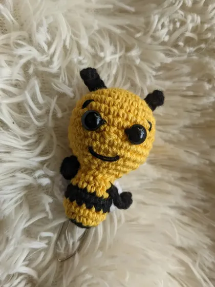 A cute honey bee bookmark, designed to peek out from the top of your book.