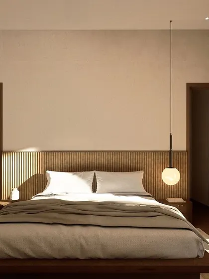 This bedroom in Kumo House is a restful retreat, featuring a low-profile bed and a fluted wood headboard. A single pendant light adds a touch of elegance and provides soft, ambient illumination.