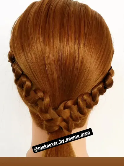 This half-up style features two Dutch braids that cross over at the back. It's a lovely and practical style that adds a bit of detail to long, open hair.