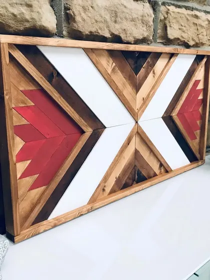 The side perspective of the large Aztec art piece reveals the solid wood frame and the texture of the assembled wooden blocks.