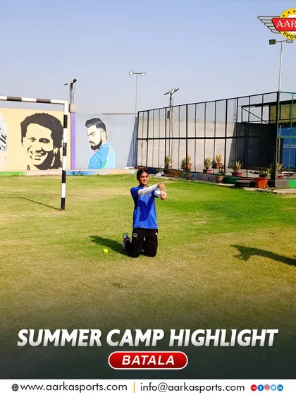 Students engaged in a catching drill during the summer camp, with murals of cricket legends inspiring them in the background.