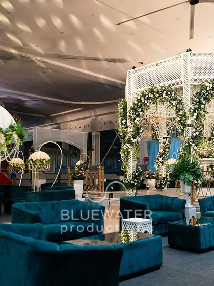 Another angle of the spacious lounge, showcasing the heart-shaped floral stands and the white gazebo-style photo booth.
