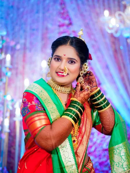 A lovely getting-ready shot of the bride adjusting her earring. This captures a moment of final touches, with her happy expression reflecting the joy of the day.