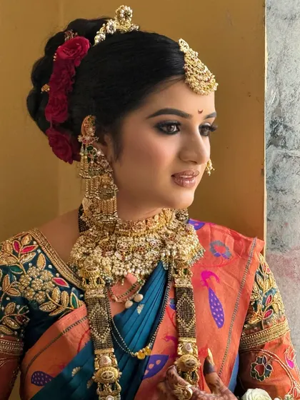 A close-up of the bride's makeup and heavy gold jewellery, showing the intricate details.