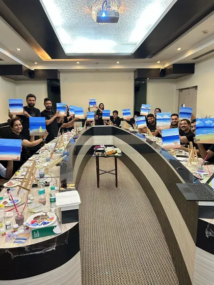The whole team at GoLive proudly holding up their individual canvases. It's so rewarding to see everyone's unique interpretation of the same theme.