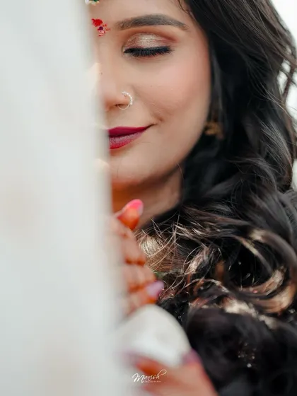 An artistic close-up of the bride, her face partially obscured, creating a soft and intimate portrait.