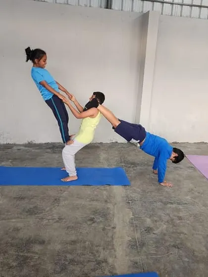 Expanding on a partner balance, this three-person pose adds another layer of complexity and fun, requiring even greater communication.