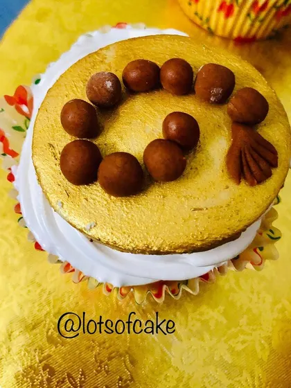 This Bakrid cupcake is decorated with fondant prayer beads on a gold-dusted surface.