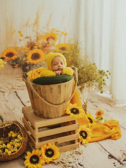 A wider perspective of the sunflower-themed setup, showing the careful arrangement of flowers and props that create a cheerful and vibrant scene.