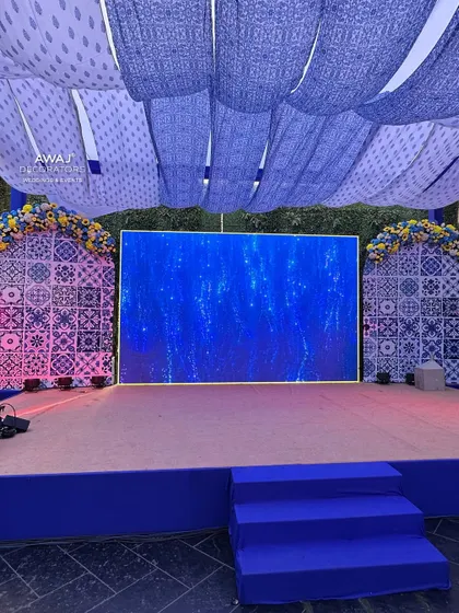 The main stage for the Haldi event, featuring a large LED screen set within a backdrop of traditional blue and white patterns.
