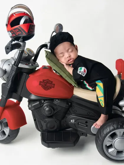 Even bikers need a nap. This little guy is sleeping right on his motorcycle.
