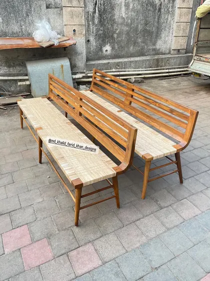 A pair of long benches crafted from solid teak with woven seats. These are inspired by classic mid-century designs and are perfect for waiting areas, galleries, or as alternative dining seating.