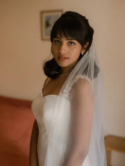 A beautiful portrait of Shruti with her veil. The soft makeup and elegant hairstyle create a timeless and romantic bridal look.