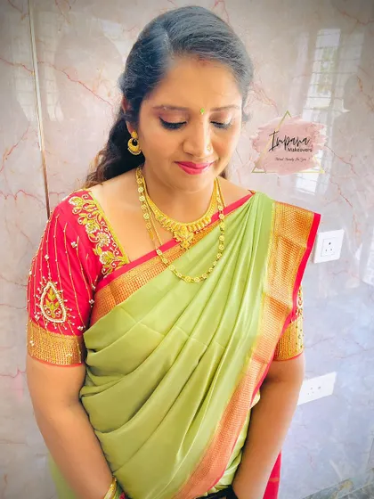 A beautiful makeover for a housewarming ceremony. The client looks radiant in her light green silk saree with soft, complementary makeup.